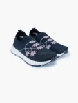 Pair of navy floral knit slip-on walking shoes for women with white soles, shown in a front angled view.