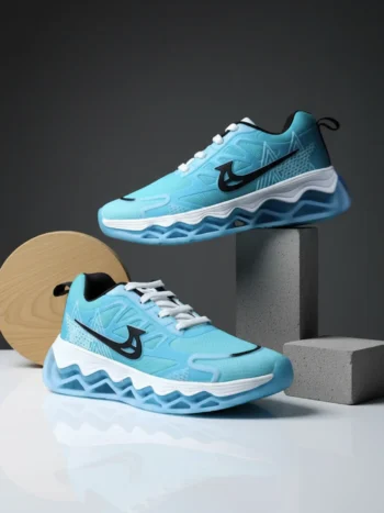 Light blue cushioned sneakers with breathable mesh upper and sculpted sole, displayed in a modern studio setup highlighting sporty streetwear design.