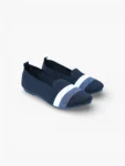 Pair of navy blue knit slip-on loafers for women with white zigzag stripe and pointed toe, angled view.